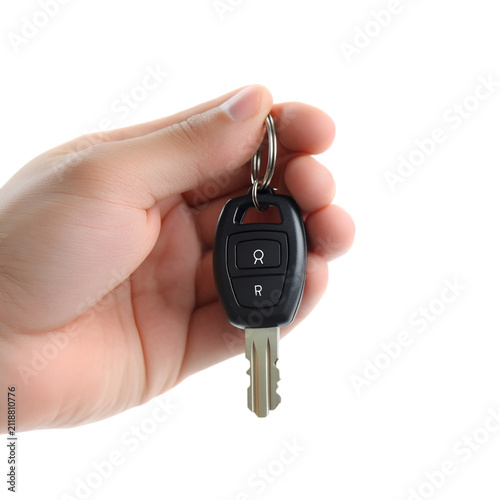 Hand holding a car key with remote control isolated on transparent background