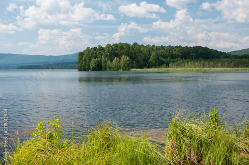 Landscape summer view of lake Turgoyak surrounded by green forests, South Urals, Russian Federation