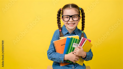 Smiling school girl holding notebooks. Happy student with glasses isolated on transparent.