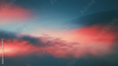 The soft light of the morning sun illuminates the vibrant clouds in the sky creating a peaceful and beautiful atmosphere during the early hours of the day
