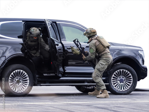 Bild auf Leinwand Tactical special forces operators exiting a black SUV during an operation for a