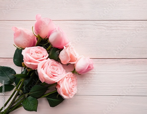 soft pink rose bouquet on bright pastel background for elegant floral flat lay design on light wooden background