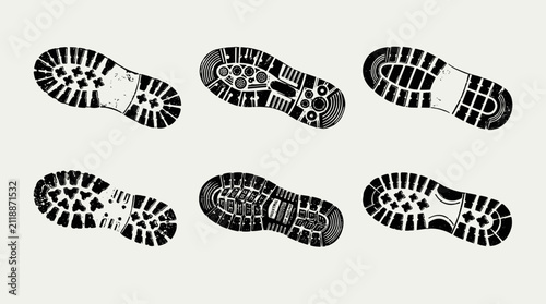 Collection of six different boot sole footprints on a neutral background.