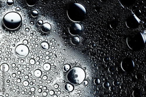 Oil and water droplets creating abstract monochrome texture