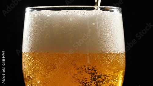 Golden Beer Pouring into Glass with Foamy Head, Refreshing Drink Close-up