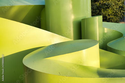 Fotografie Bold curved forms in vivid green and yellow dominate the frame