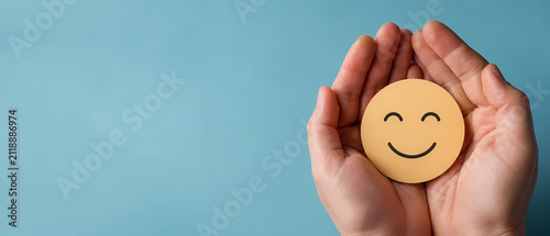 World Mental Health Day banner with hands holding a happy smile face, symbolizing emotional wellbeing, support, care and positivity