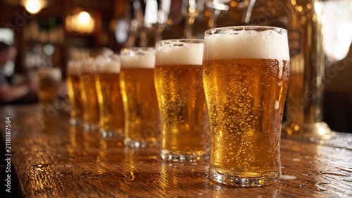 Row of Frothy Beer Glasses Lined Up on a Bar Counter