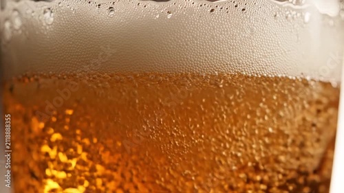Refreshing Amber Ale Beer Bubbles Rising in Glass, Close-up Macro Shot