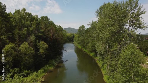 Scenic river view from boat in green forest. Travel experience, summer tourism, adventure and relaxation in nature.