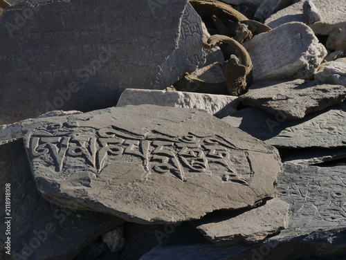 tibetan buddhism rock carving on Mani wall. Prayers engraved on stone in the himalaya, ladakh