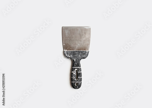 Konstfotografi Worn Metal Putty Knife with Black Handle Isolated