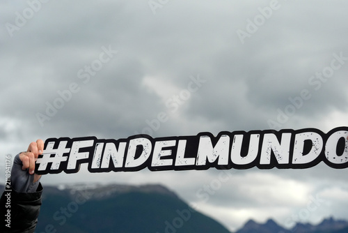 ushuaia fin del mundo sign holded by tourist