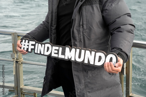 ushuaia fin del mundo sign holded by tourist