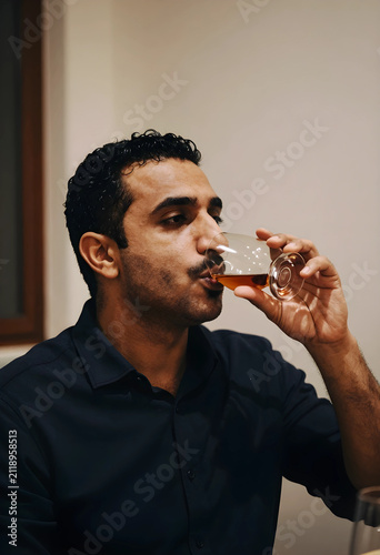 Young adult man in a dark s...