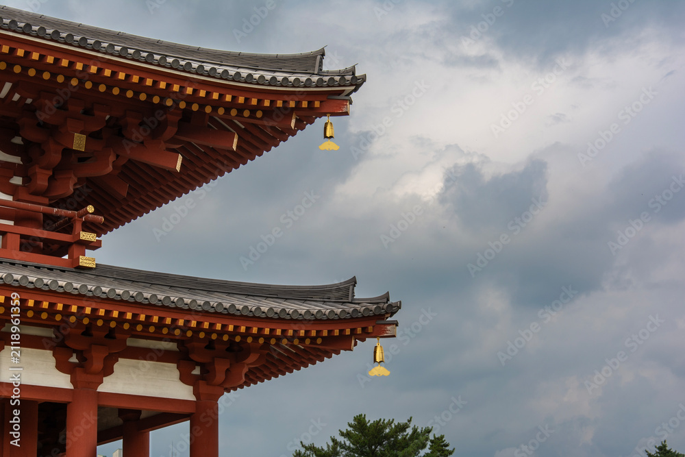 Fototapeta premium Traditional Japanese Temple Roof Eaves Against Cloudy Sky