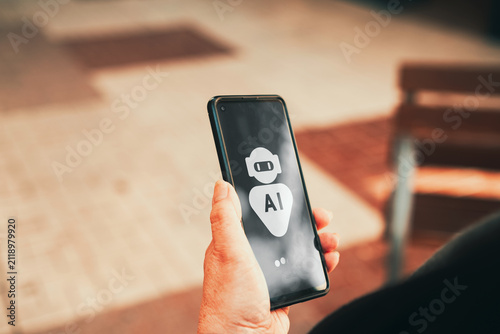Mature woman using AI chatbot assistant on smartphone outdoors. AI technology adoption, digital assistants, and mobile innovation among older adults concepts.