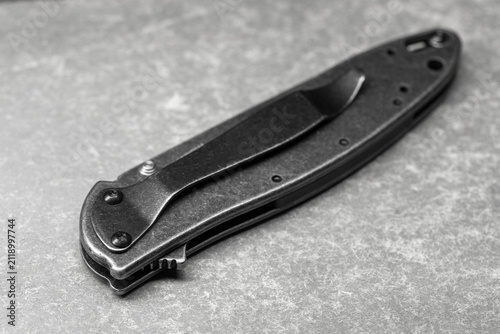 Canvas Print Closed folding pocket knife with pocket clip photographed in black and white, em