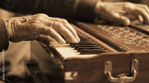 Elderly Hands Play Harmonium, Traditional Indian Music Instrument, Close Up