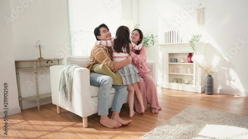 Family Gathering in a Bright Living Room With Parents and Child Sharing a Moment