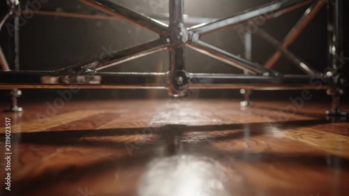 Abstract Metal Structure on Wooden Floor with Spotlight