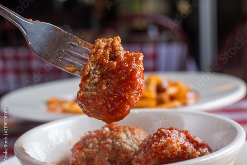 Meatballs dripping in sauce