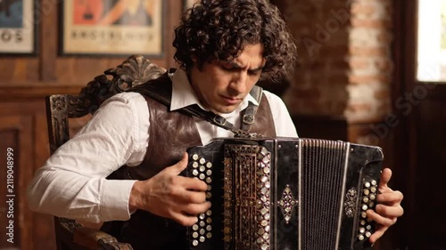 Musician playing accordion with passion in a rustic room