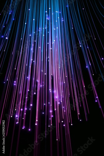Colorful lights hang in a dark space, creating a curtain-like effect with many bright points shining down