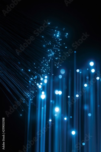Colorful lights shine in darkness creating a pattern and effect in a dark background showing movement and brightness