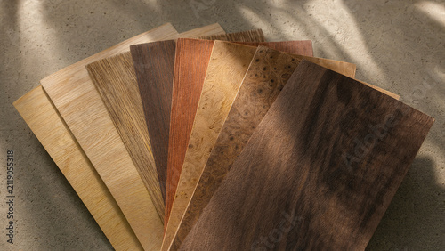 Fan arrangement of wood veneer samples showing diverse natural grain textures on stone background