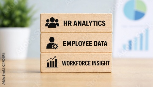 Three cardboard blocks displaying HR analytics employee data and workforce insight concepts with icons on light wooden surface