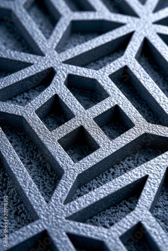 Perforated steel plate with intricate geometric lattice pattern in a sharp macro shot for industrial manufacturing and architectural branding