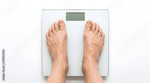 Person standing on a digital bathroom scale for weight check