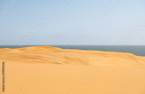 Sand dunes with vehicle tracks in the sand in the Namib desert just south of Walvis Bay, Namibia, Africa