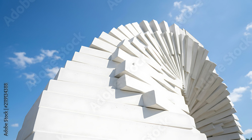 Modern white spiral architecture against a clear blue sky