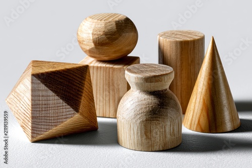 Wooden geometric shapes cluster on a minimalist background featuring sharp macro focus and dramatic lighting for architectural design branding