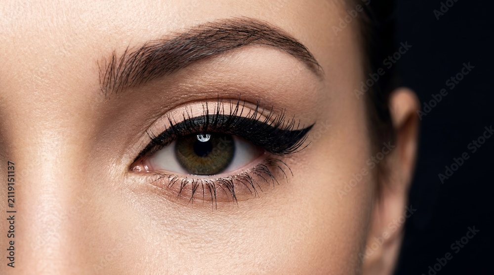 Naklejka premium Cat eye eyeliner woman eye makeup lashes beauty cosmetics dramatic showing winged line concept for cosmetic advertising makeup tutorials fashion editorials salon services and glamour campaigns