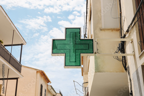 Canvastavla Green pharmacy cross hangs outside