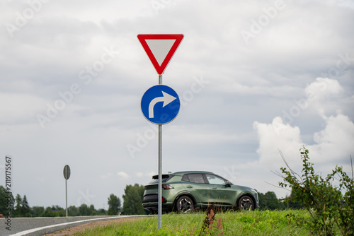 Canvastavla Inverted triangular yield sign and blue round right turn mandatory sign regulati