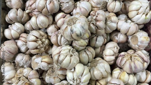 A pile of fresh garlic. A kitchen staple always used in cooking. A video of garlic featuring smooth movement.