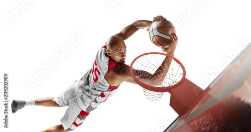 Basketball player in a jump throws the ball into the ring. Sports energy. Sports emotions. Professional basketball player in action. Isolated