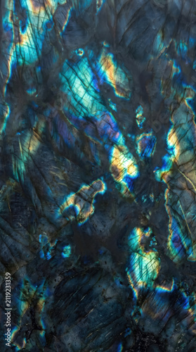 Abstract background of labradorite gemstone with vivid blue and gold iridescence