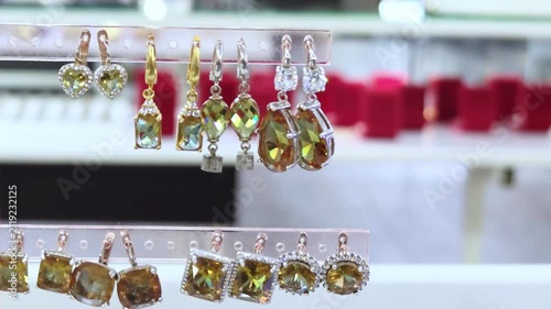 Earrings and rings displayed at a local market stall. Jewelry on display with earrings.	