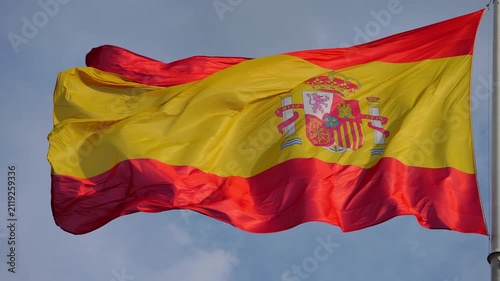 Spanish flag with coat of arms waving