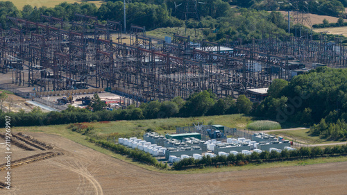 Aerial view of the Pelham Storage Limited battery facility and adjacent electrical substation, with rows of white storage containers in Bishop's Stortford, England, United Kingdom.