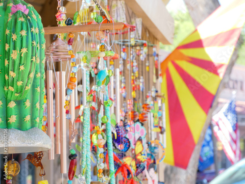 colorful mobiles, wind chimes, flags on display with blur effect