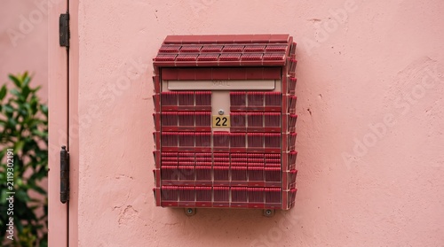 Creative Matchbook Covered Wall Mounted Mailbox on Pink Plaster Surface