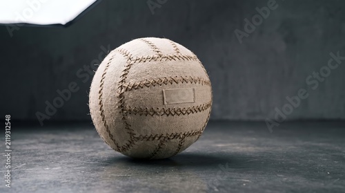 Vintage Handcrafted Canvas Volleyball Ball Resting on Dark Concrete Surface
