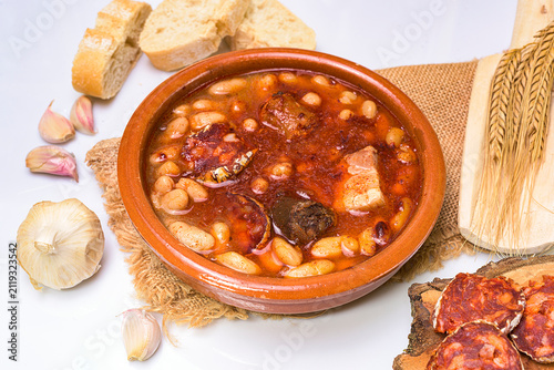 Quadro su tela Traditional Spanish fabada stew served in a clay bowl with white beans, chorizo,