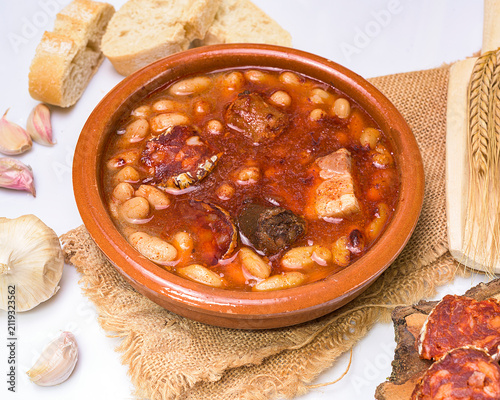 Canvastavla Traditional Spanish fabada stew served in a clay bowl with white beans, chorizo,